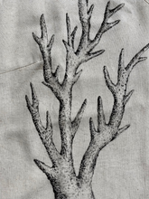 Load image into Gallery viewer, A close-up of a light beige linen garment featuring a detailed black ink-style illustration of branching coral on the front.
